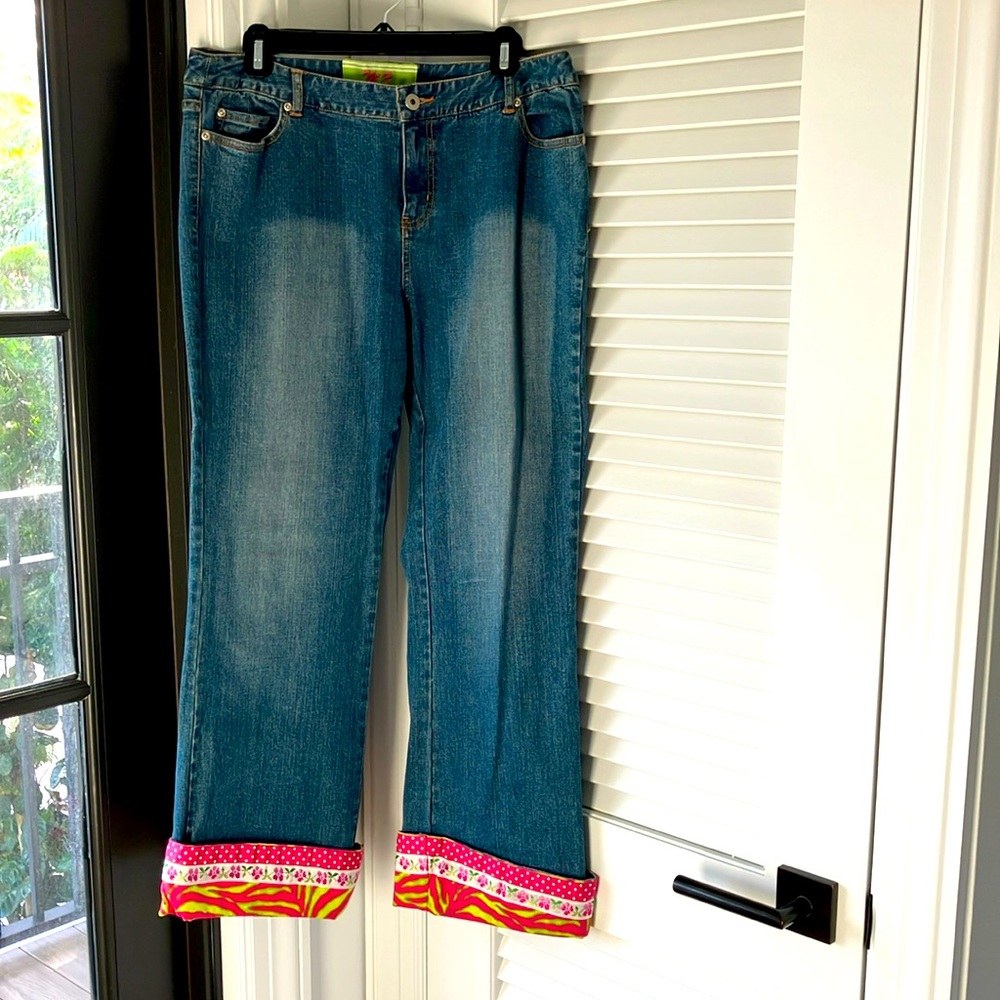 Custom cuffed faded blue jeans.